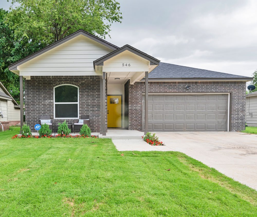 This image highlights a charming single-story home with excellent curb appeal.