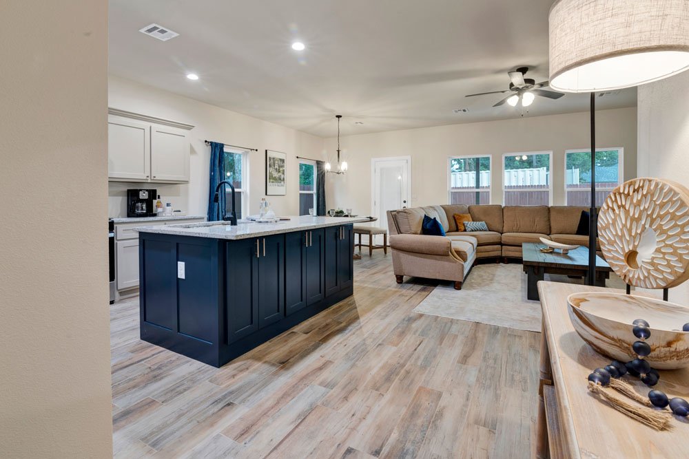 A modern open-concept living area that seamlessly blends the kitchen, dining, and living spaces, perfect for entertaining and family gatherings.