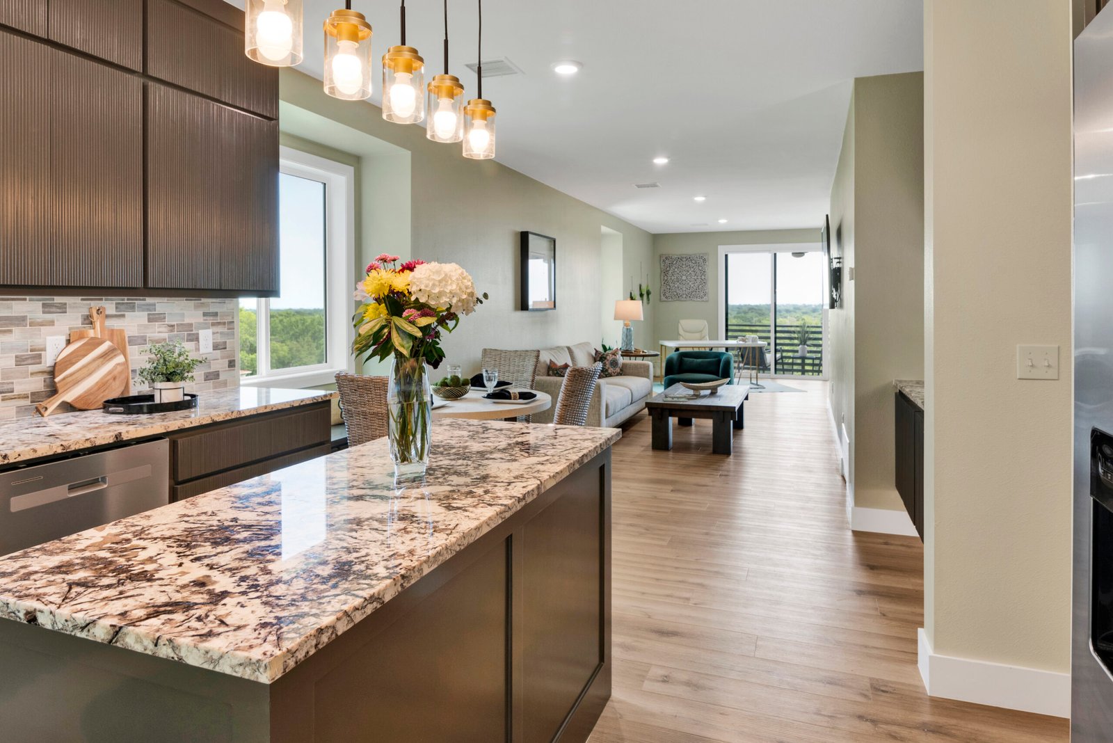 This image highlights a spacious open-concept layout that seamlessly connects the kitchen, dining, and living areas.